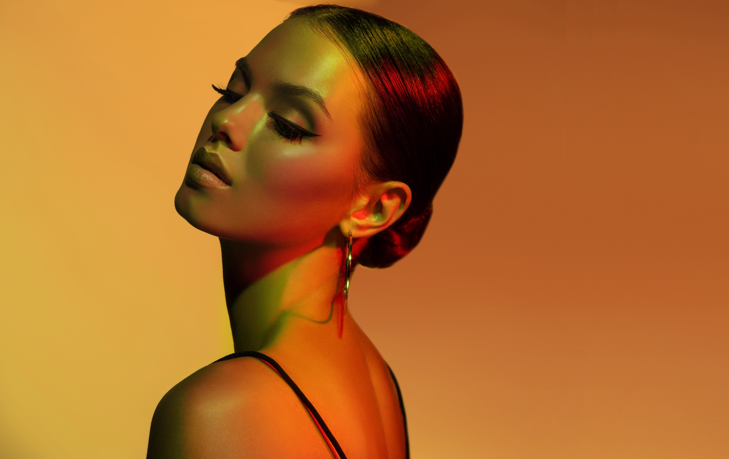 Woman in warm orange and green light