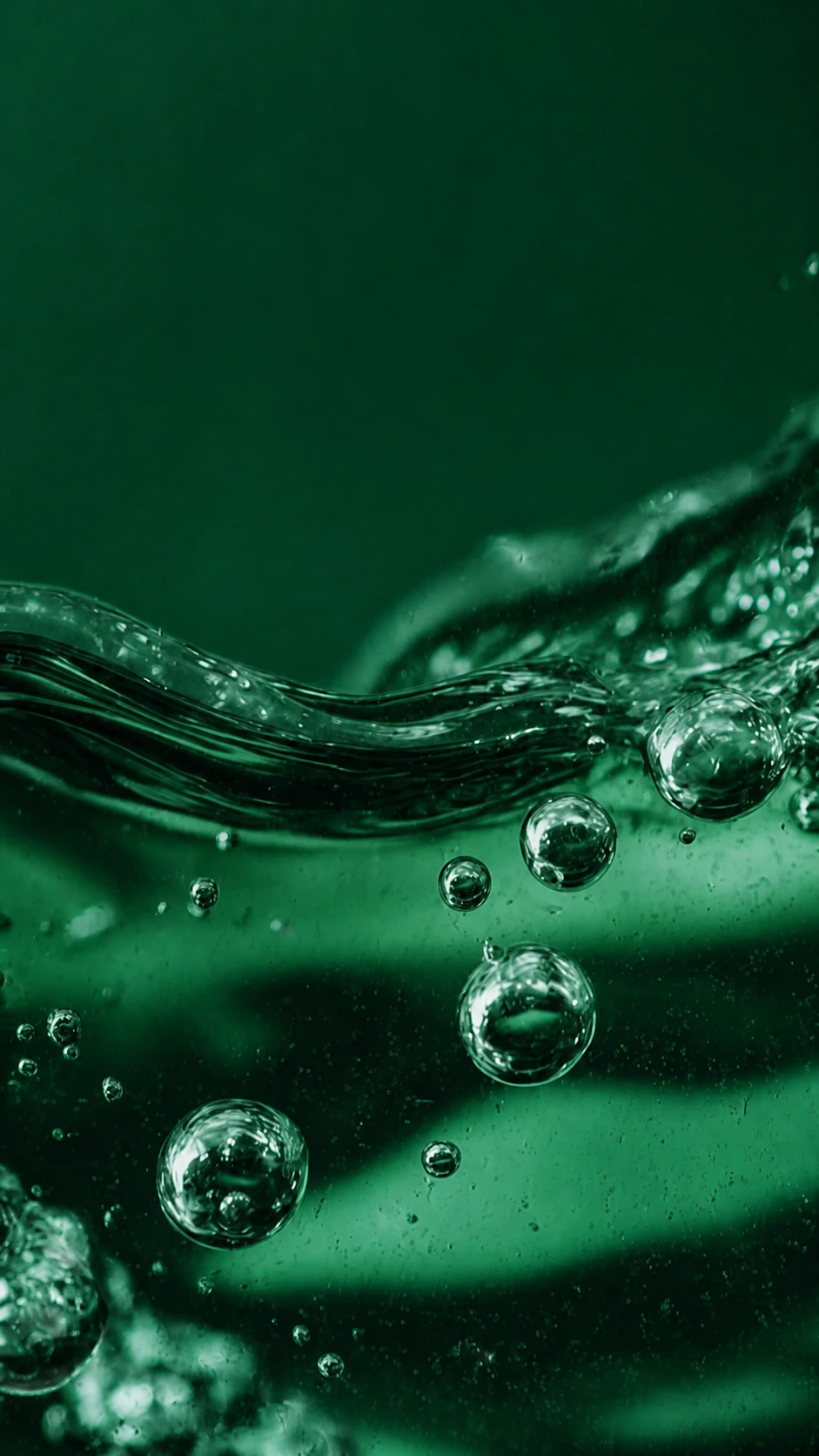 Close-up of a translucent green skincare formulation with suspended bubbles Close-up of a translucent green skincare formulation with suspended bubbles