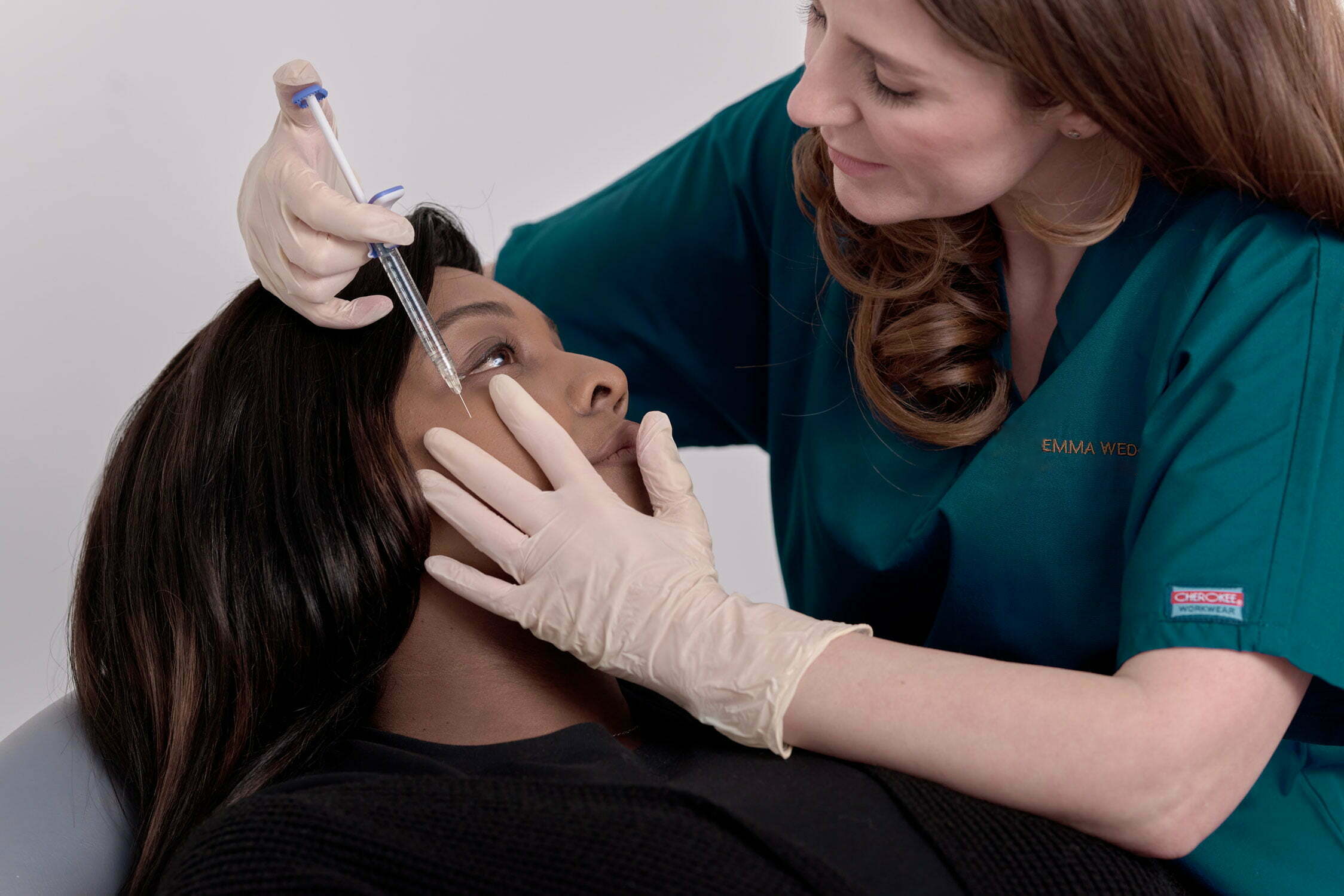 Polynucleotides Emma administering an aesthetic injection beside a patient's eye